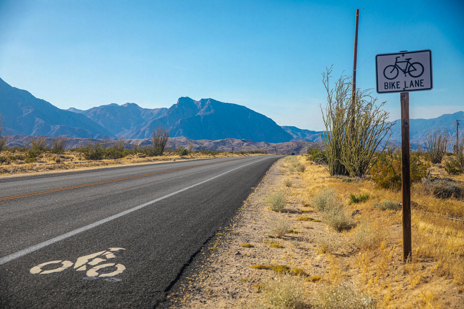 A paved bike lane on a desert road with mountains in the distance — similar in feel to the Western Beltway Trail in Summerlin