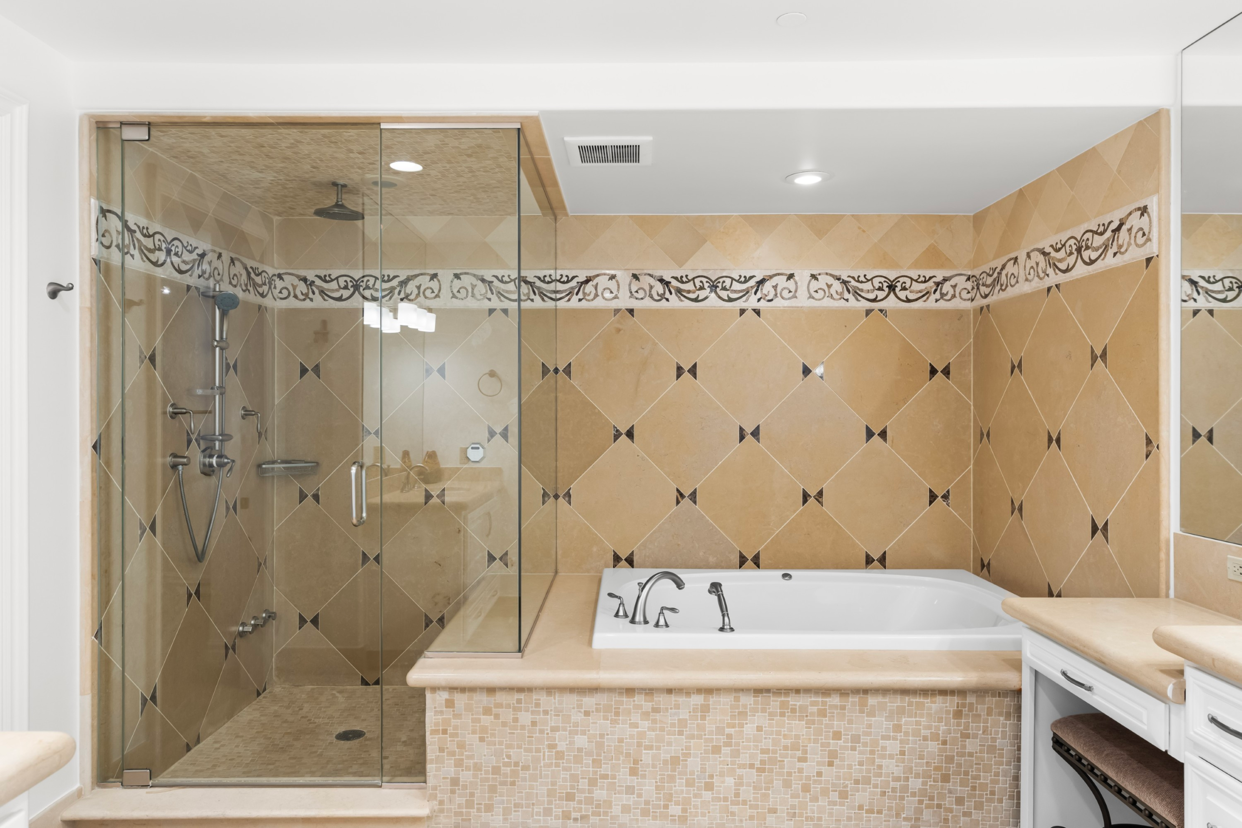 Primary bath at Residence 305 — glass-enclosed steam shower and jetted tub