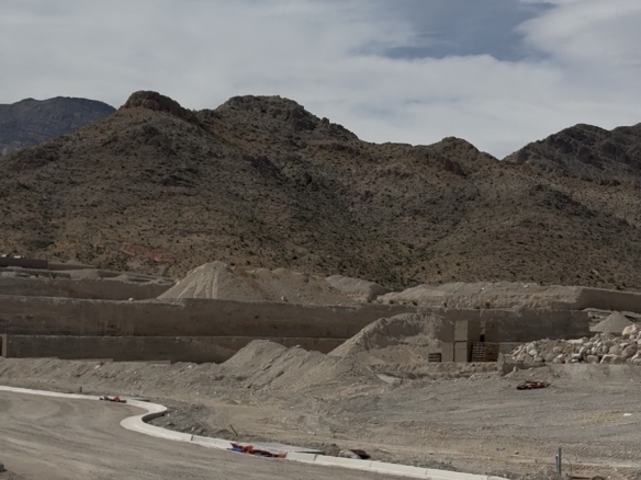 Freshly poured curbs and graded pads at La Madre Peaks Village in Summerlin West with the La Madre Mountains in the background