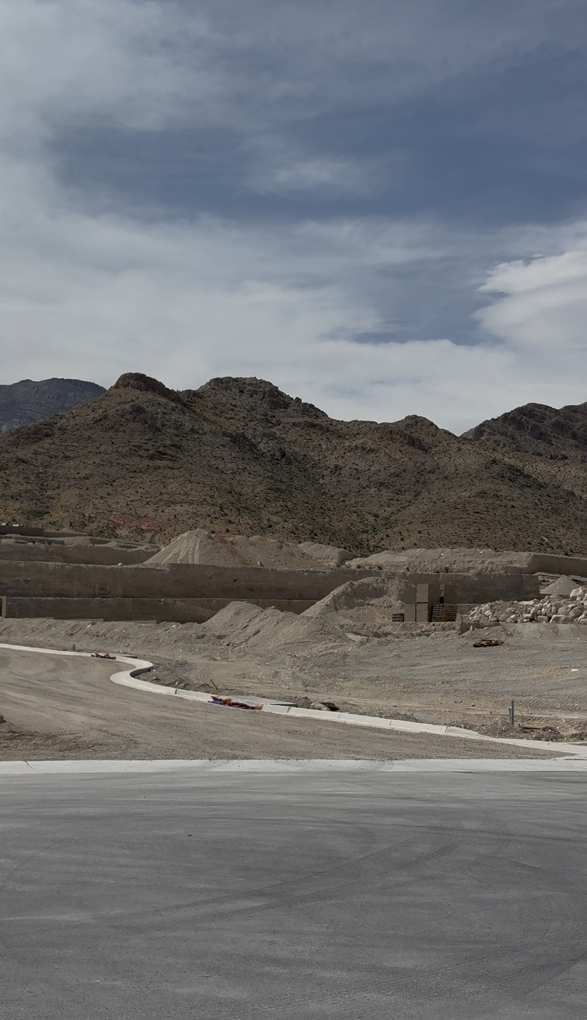 Freshly poured curbs and graded pads at La Madre Peaks Village in Summerlin West with the La Madre Mountains in the background