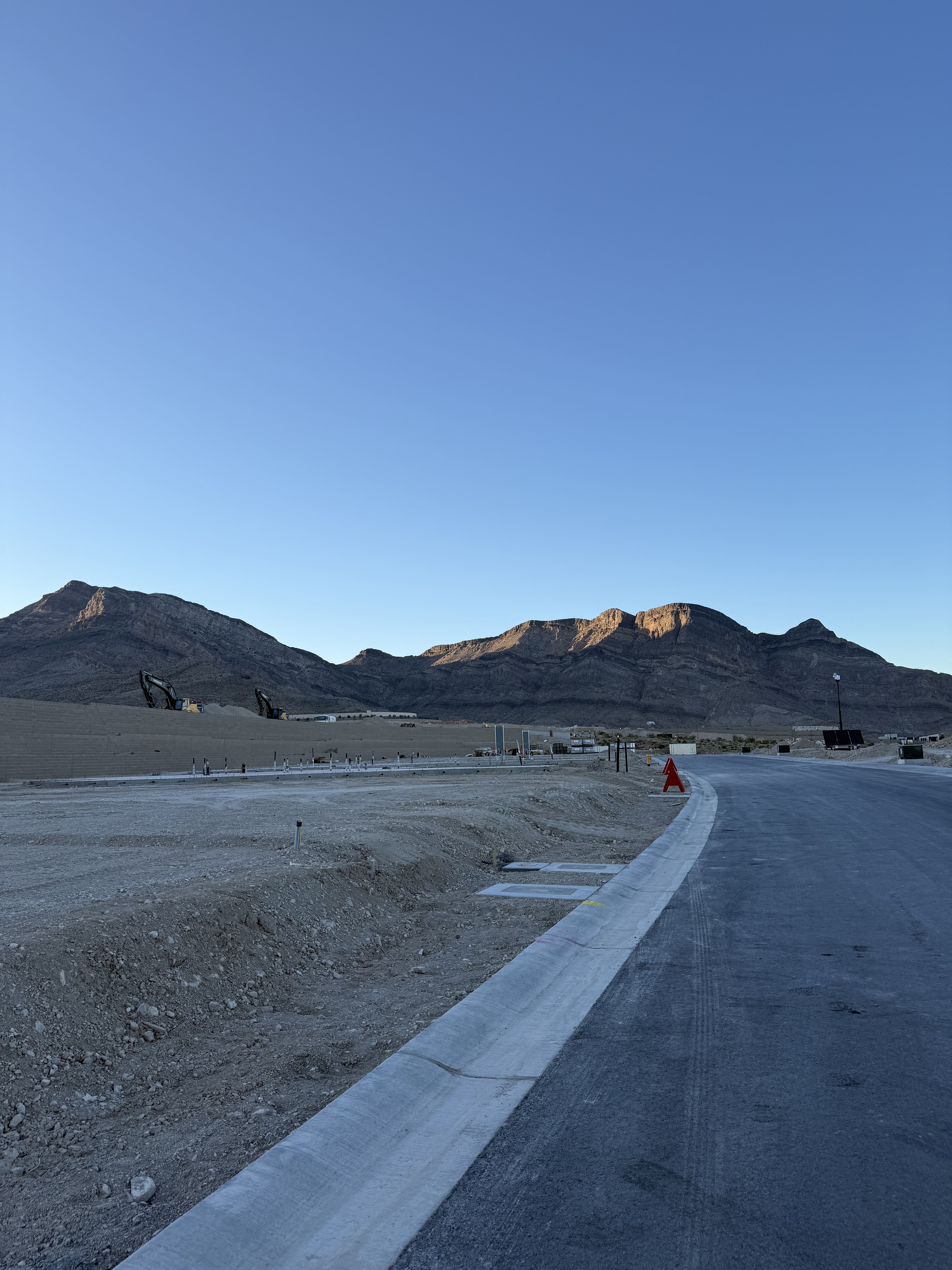 Graded home sites and new roads at La Madre Peaks with morning light on the La Madre mountain range, Summerlin West