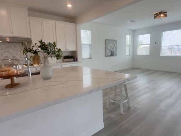 Chef kitchen with an oversized waterfall marble island in a million dollar Summerlin home