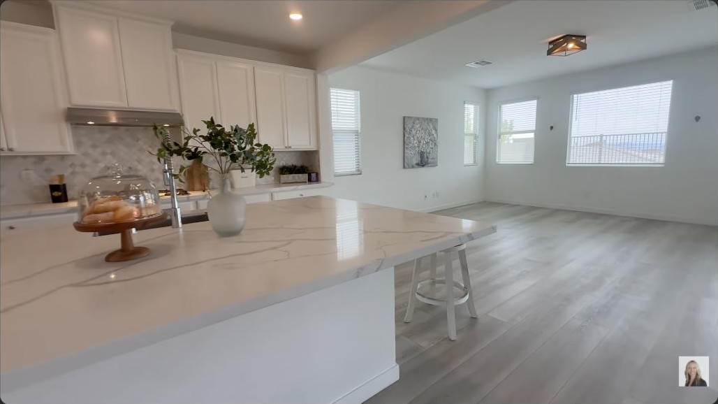 Chef kitchen with an oversized waterfall marble island in a million dollar Summerlin home