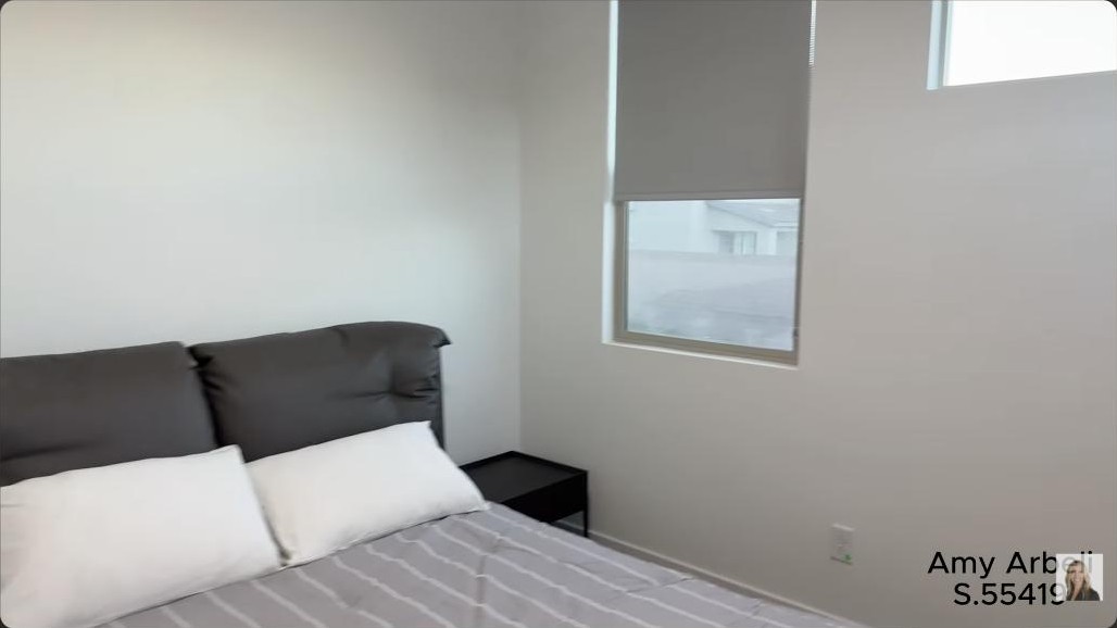 Primary bedroom with a roller-shade window in a modern Summerlin home in Redpoint