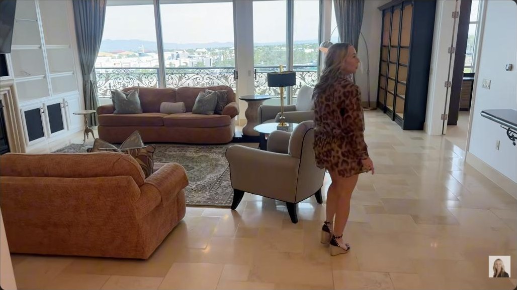Living room with floor-to-ceiling views and terrace access in the One Queenridge high rise in Summerlin
