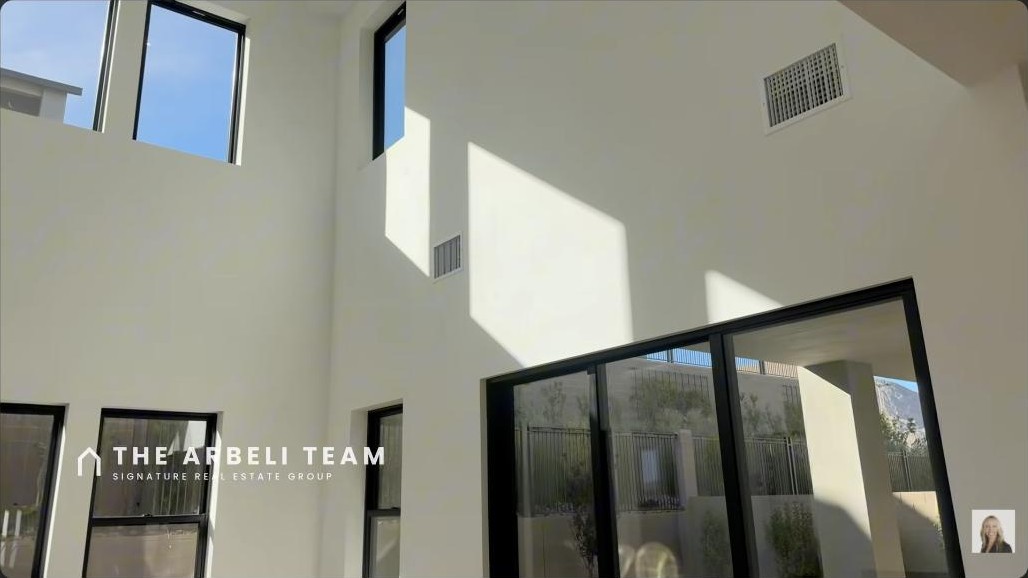 Two-story great room with stacking glass doors in a Carlisle Peak Summerlin 4-car garage home