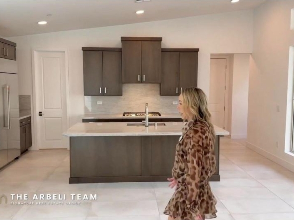Open great room and chef kitchen with quartz island in a Tri Pointe home at Summerlin Grand Park Edgewood