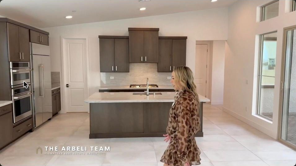 Open great room and chef kitchen with quartz island in a Tri Pointe home at Summerlin Grand Park Edgewood