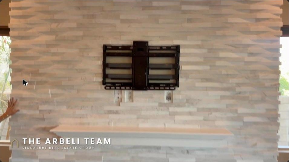 Great room with a gas fireplace and stacked-stone accent wall in a Summerlin luxury home