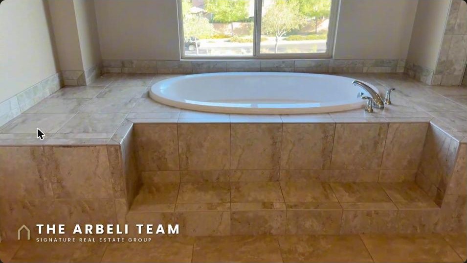 Primary bathroom with a large soaking tub and window in a Summerlin West luxury home