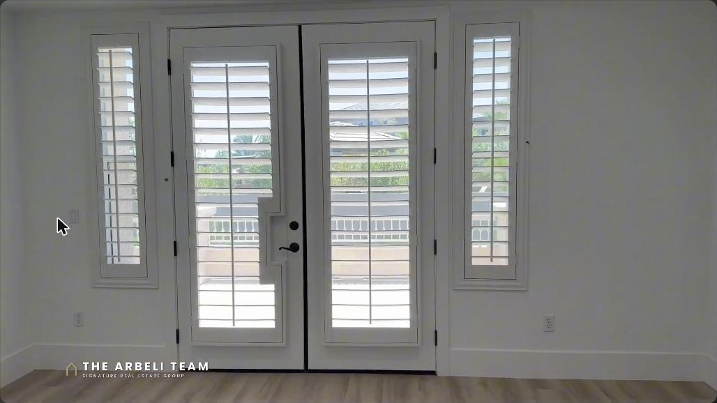 Primary bedroom with double doors to a private balcony in a Summerlin luxury estate