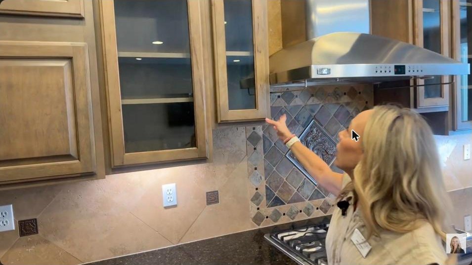 Chef kitchen range hood, tile backsplash, and gas cooktop in a Toll Brothers Summerlin West home