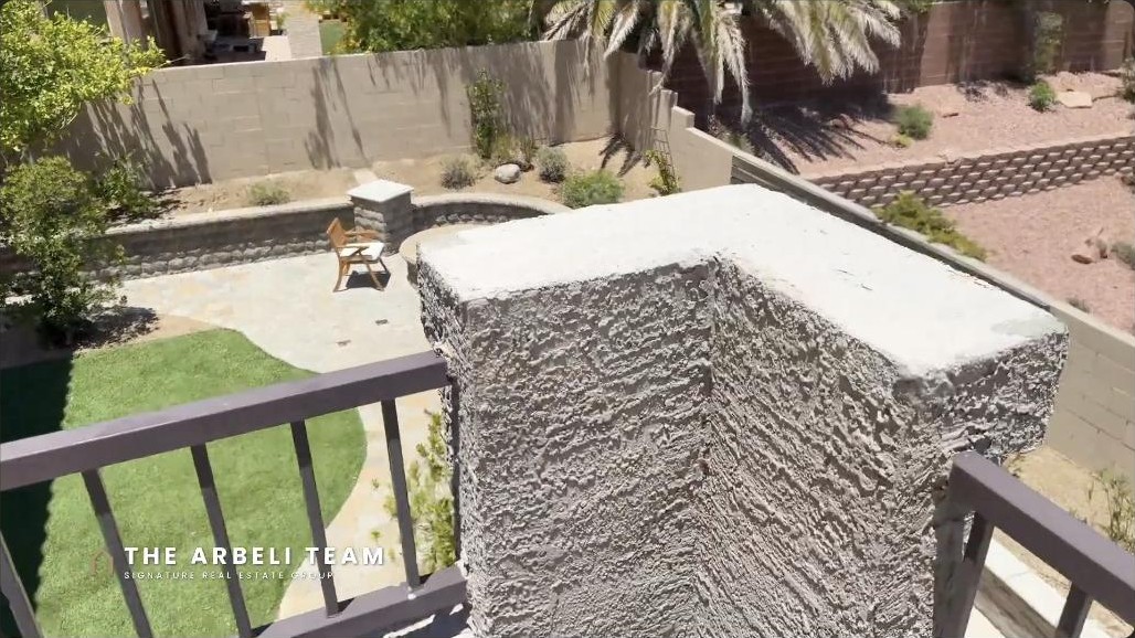 Backyard with a spa and low-maintenance landscaping at a Summerlin West luxury home