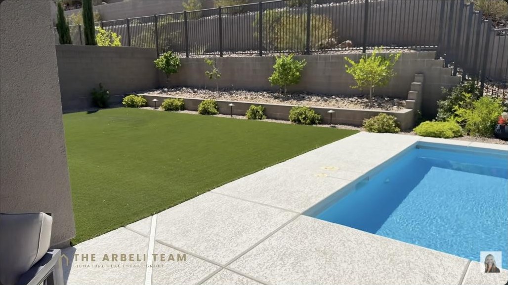 Custom pool and turf backyard on an oversized corner lot at a single-story Summerlin West home