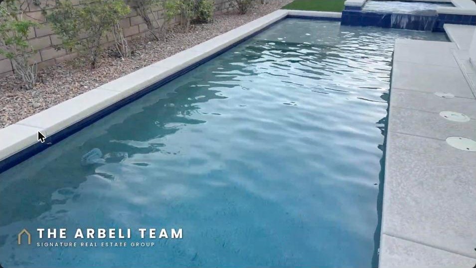 South-facing backyard pool with spa spillover at a Summerlin West Toll Brothers luxury home