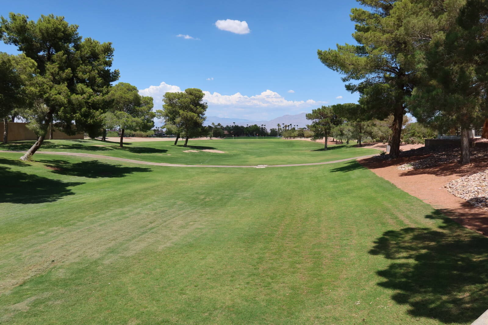 Manicured golf course fairway and greenbelt winding through Sun City Summerlin in Las Vegas