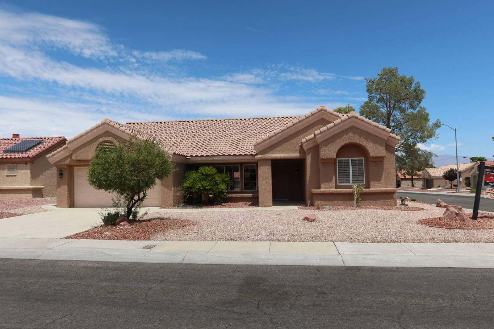 Single-story home for sale in Sun City Summerlin Las Vegas with tile roof and desert landscaping