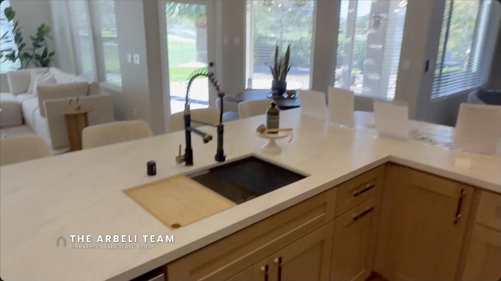 Renovated kitchen with quartz counters and a golf course view window in a Sun City Summerlin home