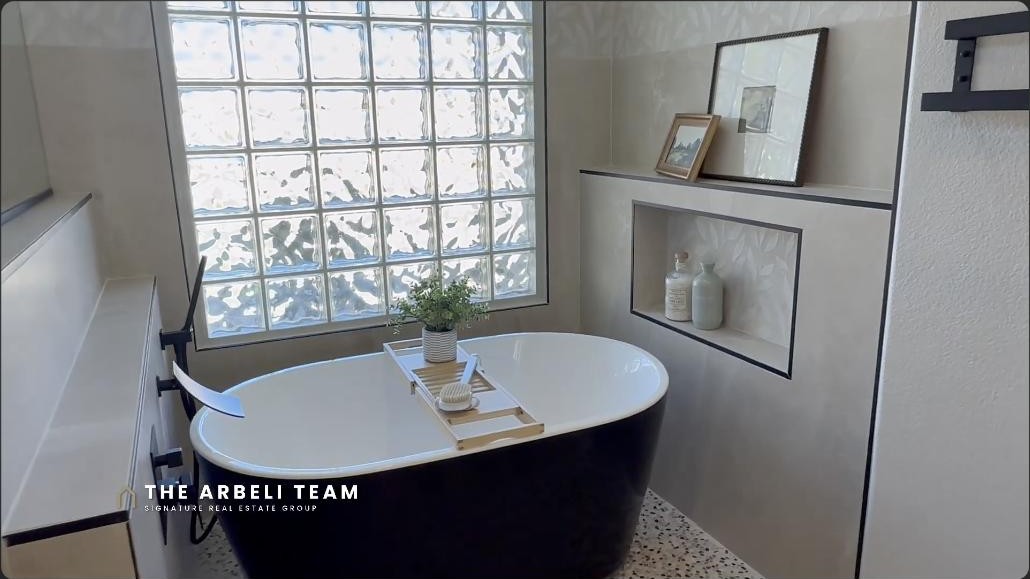 Primary bathroom with freestanding soaking tub in a Sun City Summerlin golf course home