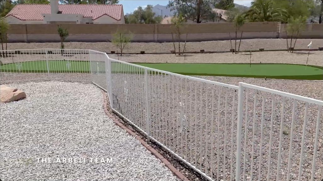 Nearly half-acre Sun City Summerlin backyard with a private putting green and mountain views
