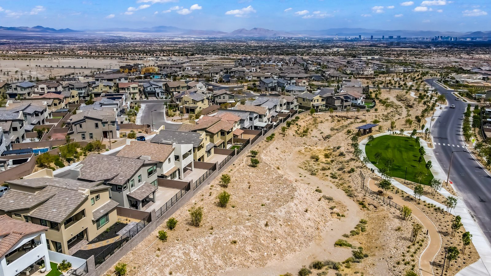 Aerial view of the Redpoint village in Summerlin West with open desert and the Las Vegas Strip in the distance