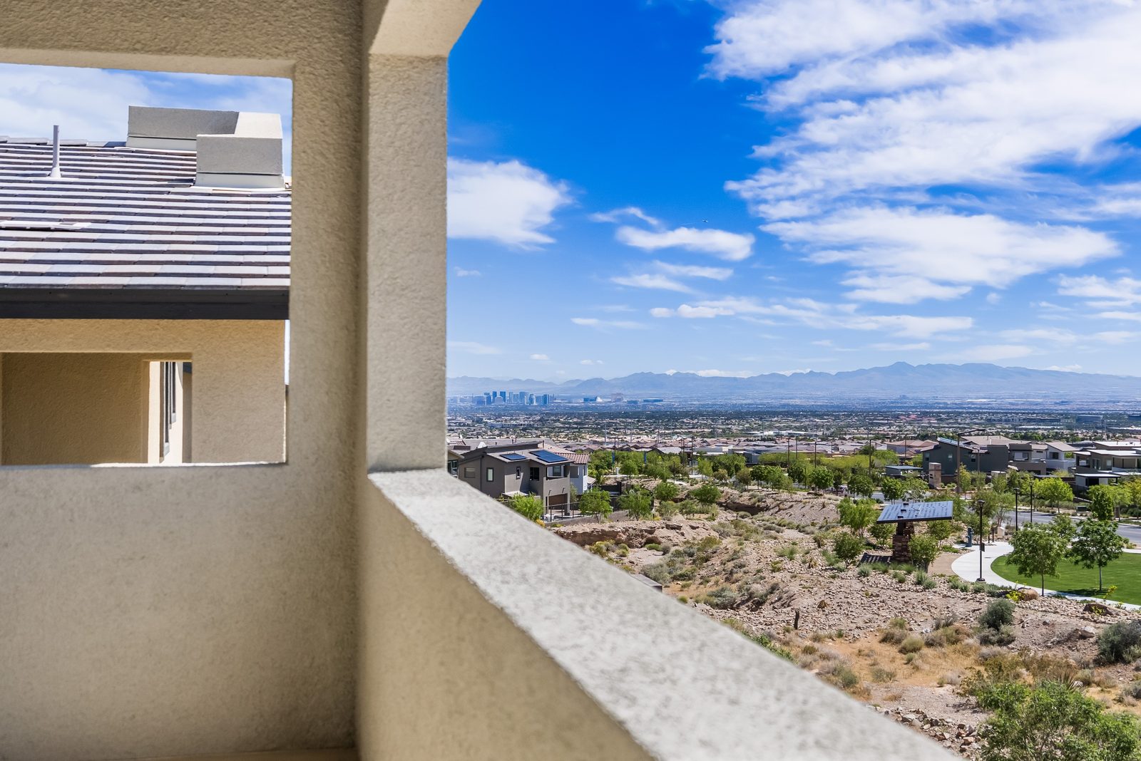 Las Vegas Strip and mountain views from the primary suite balcony at 12123 Glentana View Street