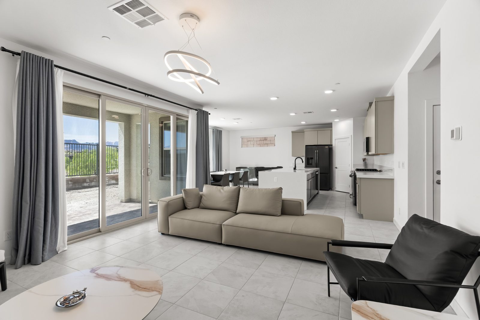Open-concept living room with sliding doors to the covered patio