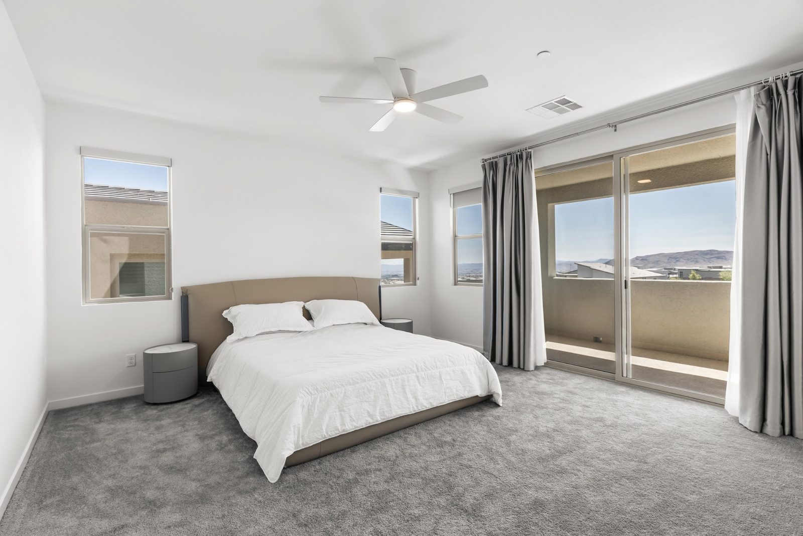 Primary bedroom suite with slider to the private second-floor balcony