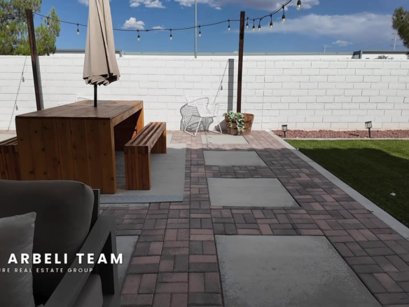 Finished backyard at 7204 Site Street with a covered lounge area and paver patio