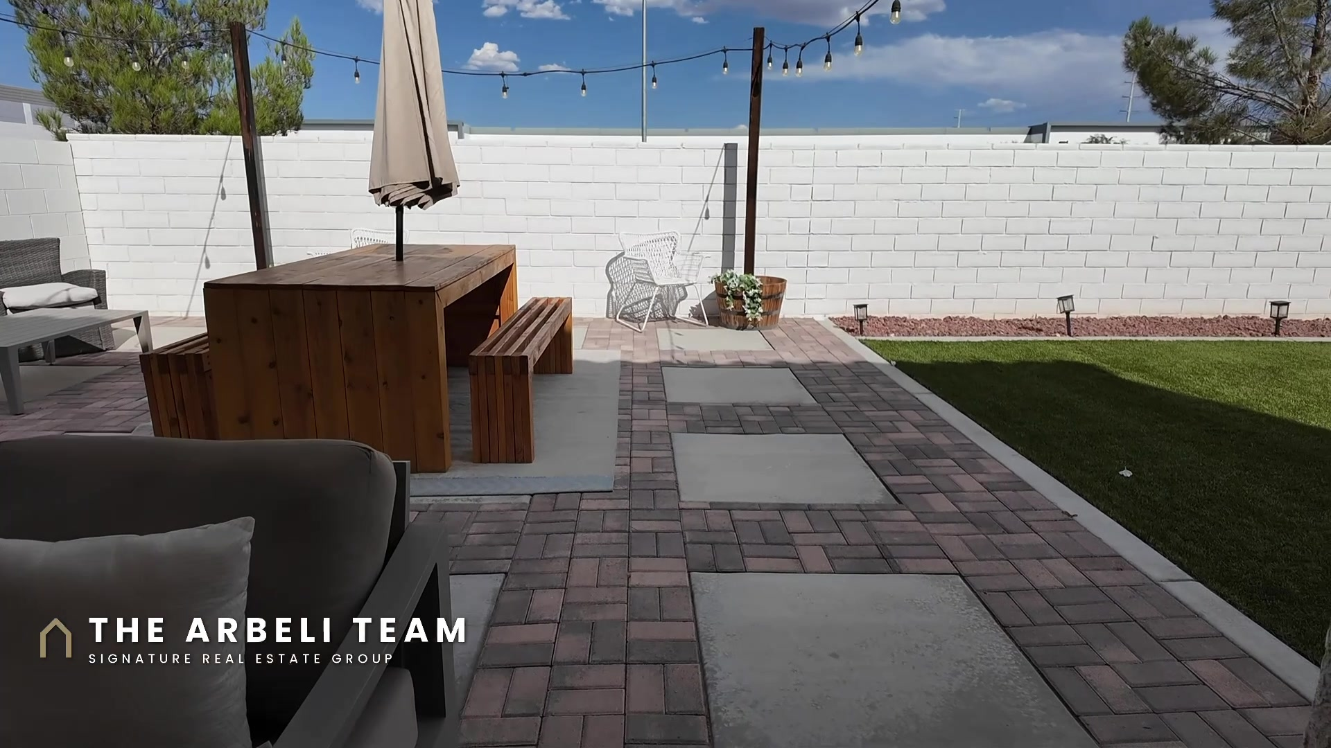 Finished backyard at 7204 Site Street with a covered lounge area and paver patio