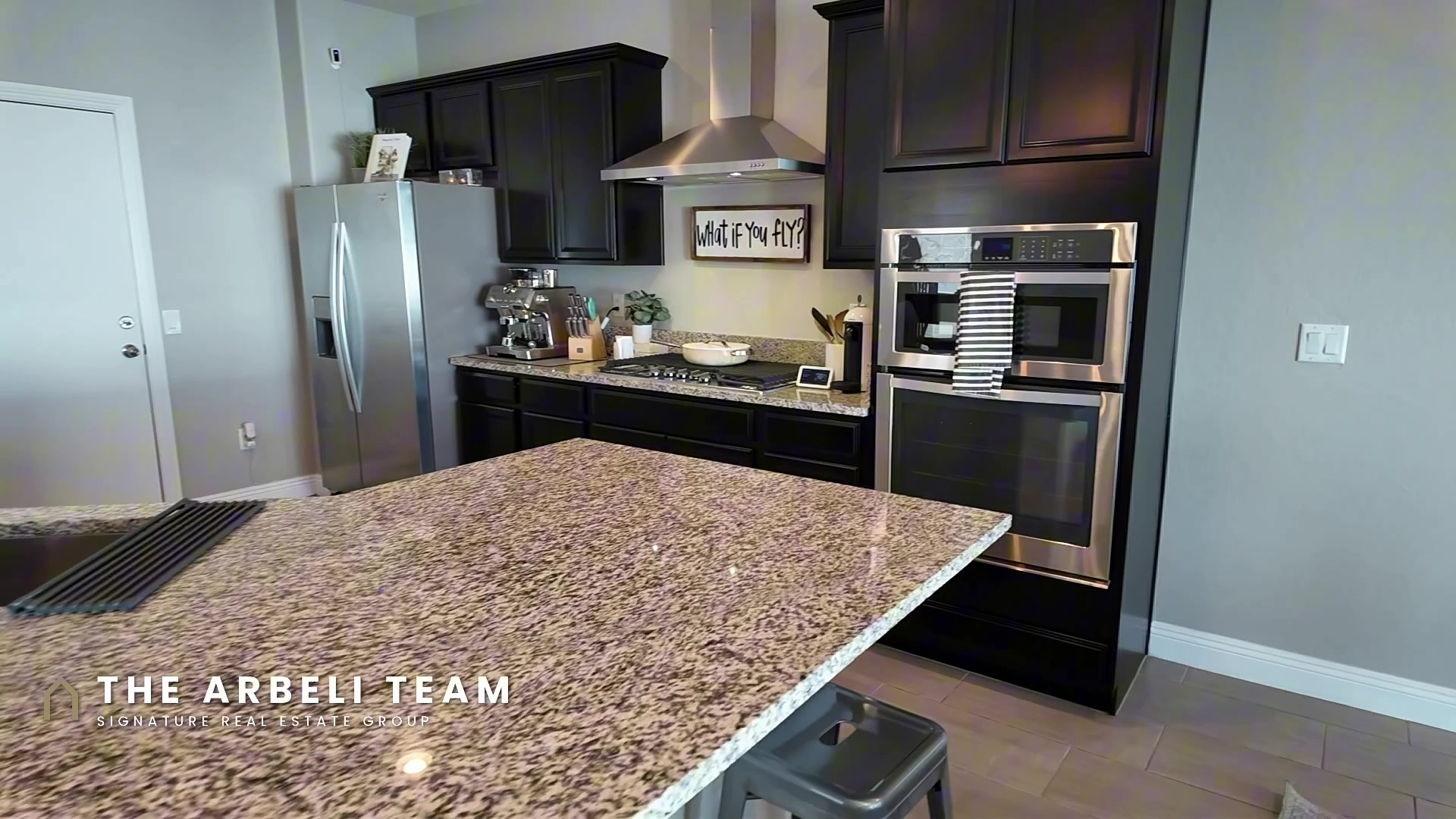 Kitchen at 7204 Site Street with granite counters, a center island, and double wall ovens