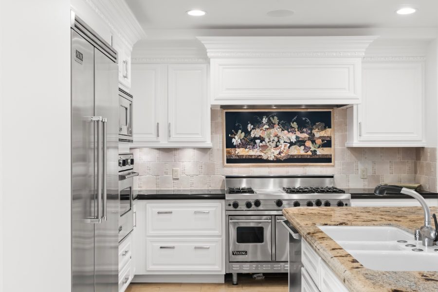 Kitchen at Residence 305, Viking range, white cabinetry, granite island