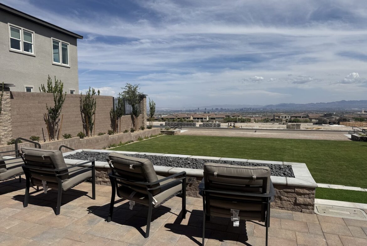 Lawn and paver seating at the Glenrock common area in Grand Park, Summerlin West, looking east toward the Las Vegas Strip skyline