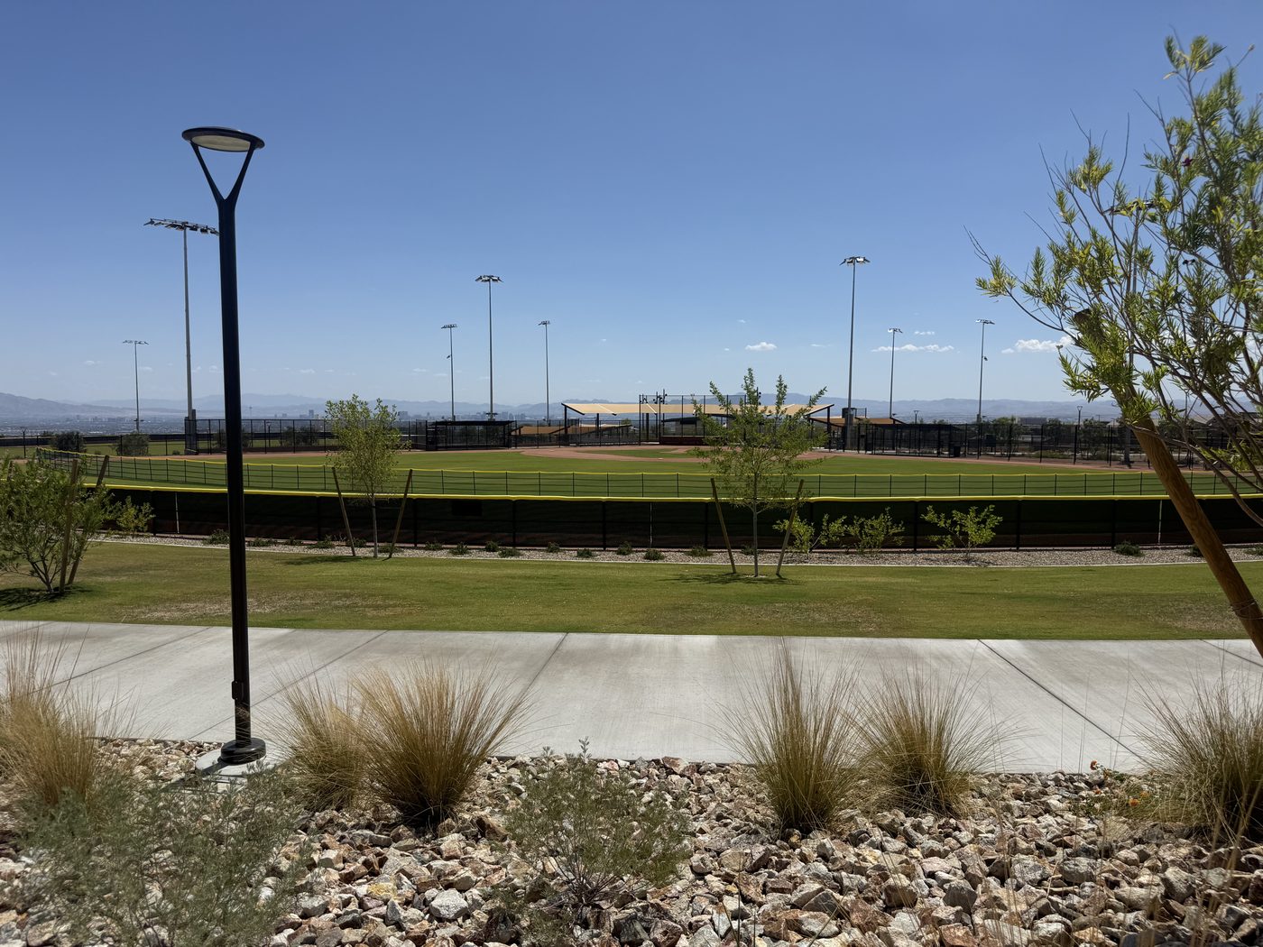 Open lawn and lighted pathway at Grand Park in Summerlin West, Las Vegas, Nevada