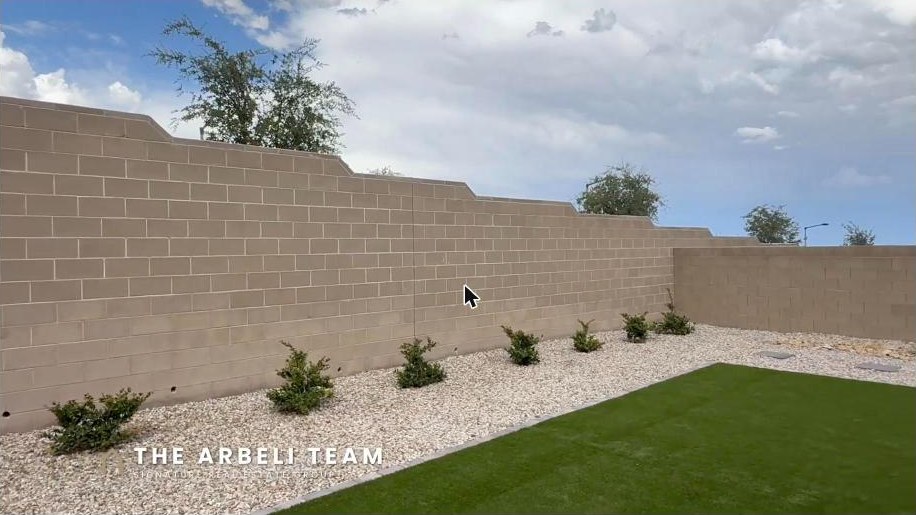 Low maintenance backyard with artificial turf and privacy walls in gated Alton at Grand Park Summerlin