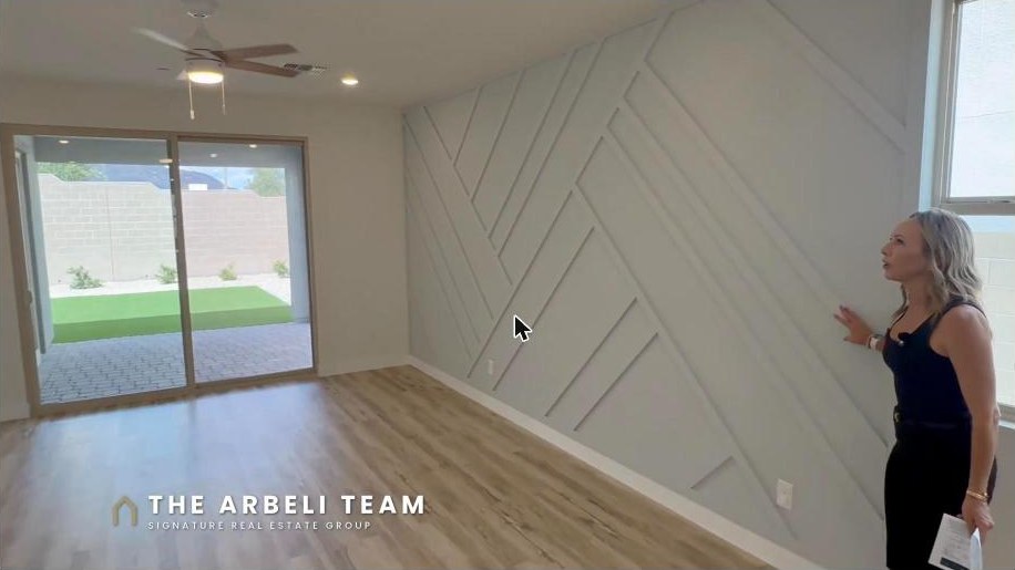 Open concept great room with accent wall and patio sliders in a Grand Park Summerlin home