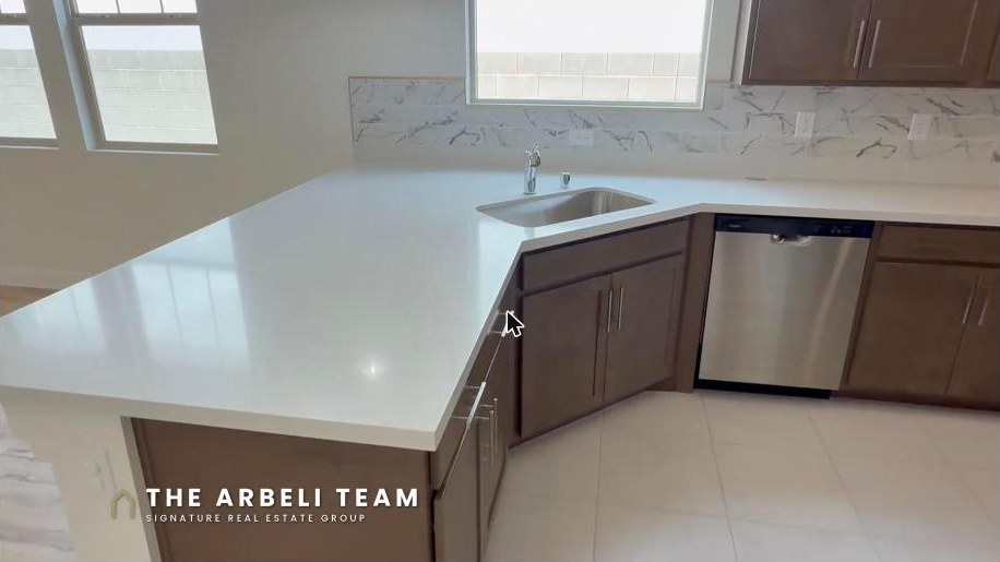 Kitchen with quartz countertops and upgraded cabinetry in a Grand Park Summerlin Las Vegas home