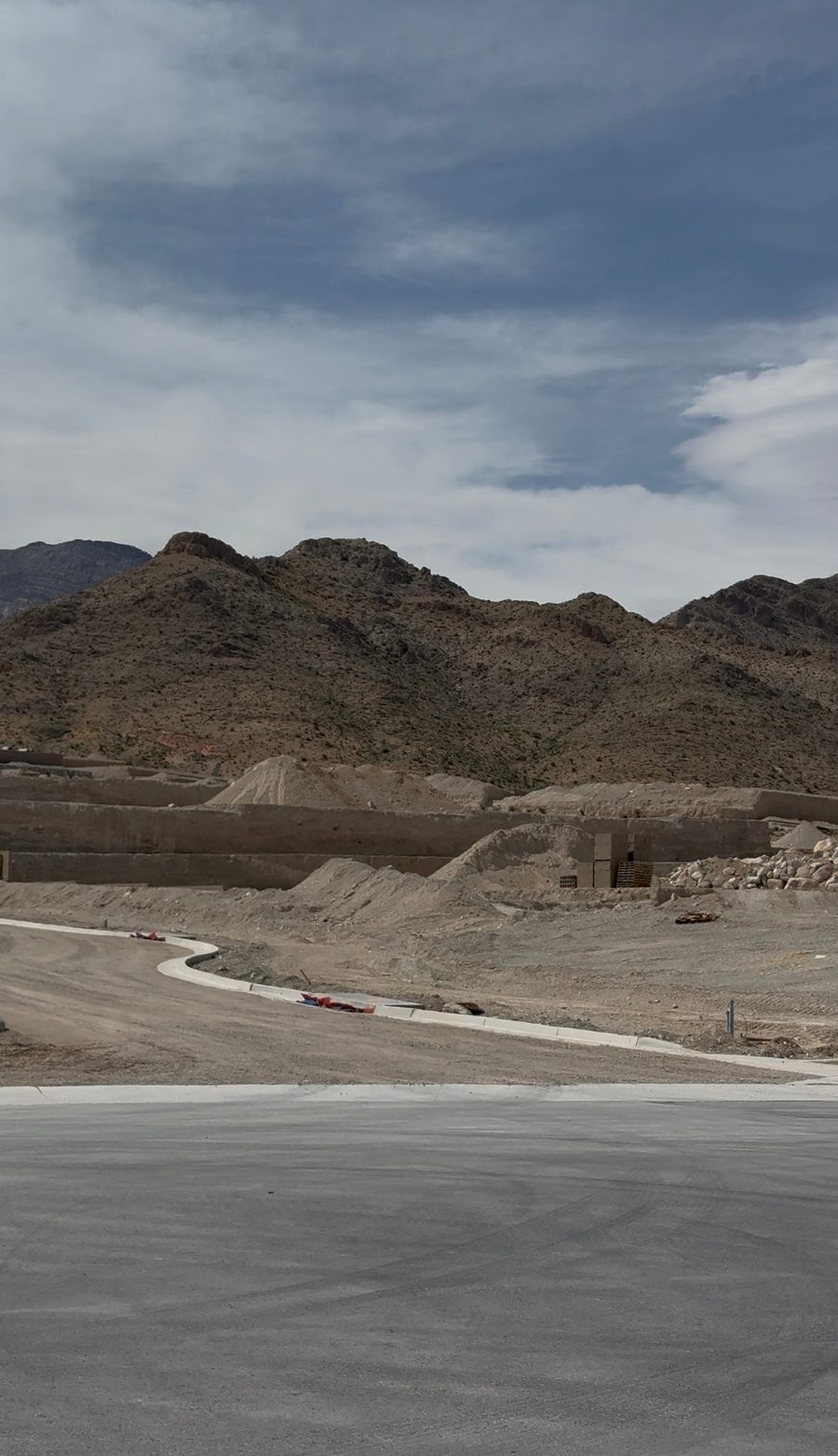 Freshly poured curbs and graded pads at La Madre Peaks Village in Summerlin West with the La Madre Mountains in the background