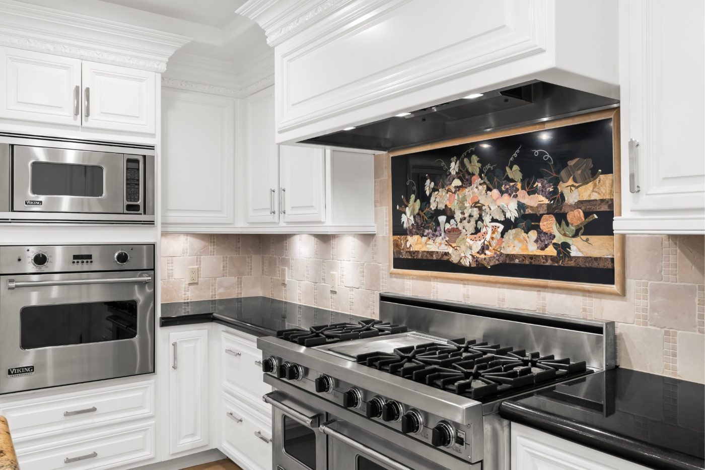 Kitchen with stainless steel double ovens and a gas cooktop in a luxury Las Vegas home