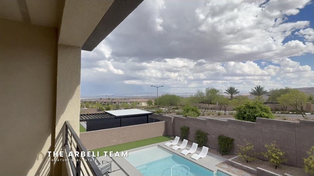 View over the pool and Summerlin West from the primary balcony in Redpoint Summerlin Las Vegas