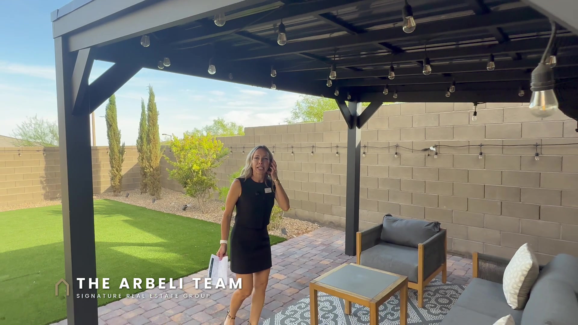 Backyard pergola with string lights in a gated Stonebridge Summerlin neighborhood