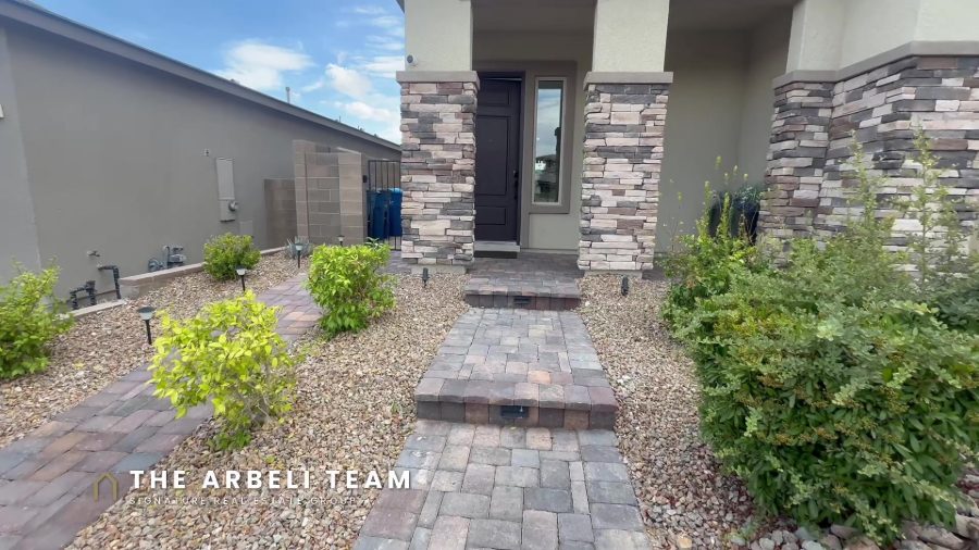 Stonebridge Summerlin home tour, front exterior of a gated Bristle Vale home with stone entry