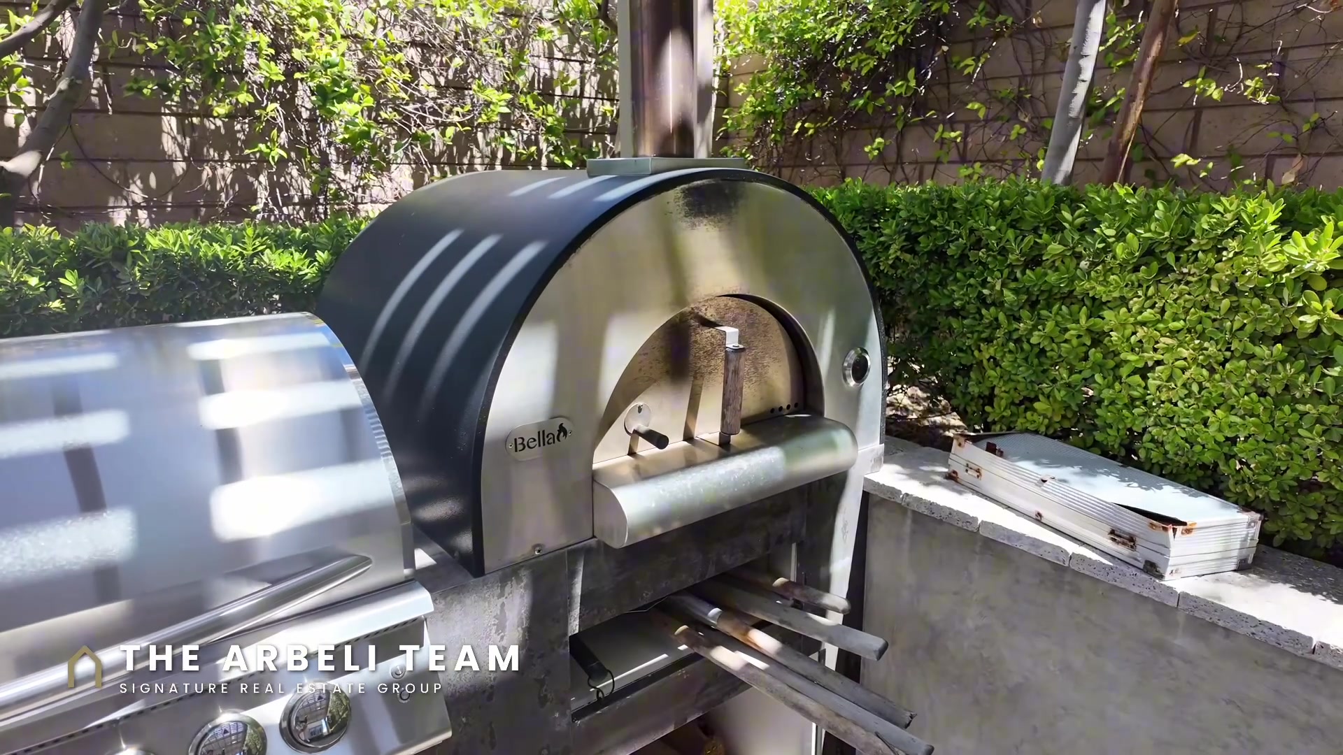 Sunken outdoor kitchen with pizza oven at a Summerlin West luxury home