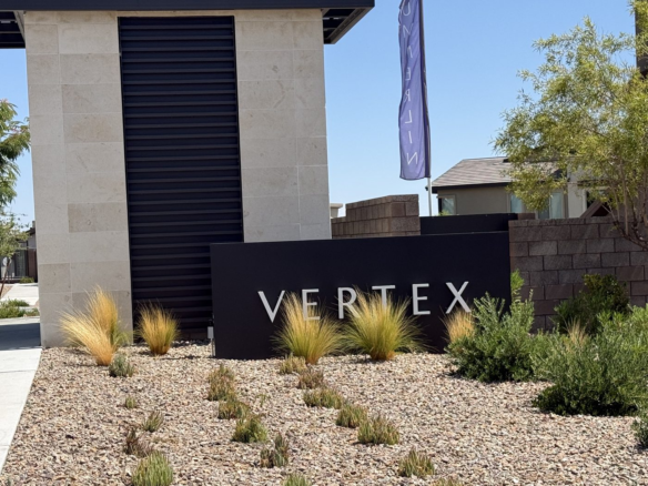 Stone and stucco entrance monument reading Vertex at the Tri Pointe Homes neighborhood in Redpoint Square, Summerlin West, Las Vegas, Nevada