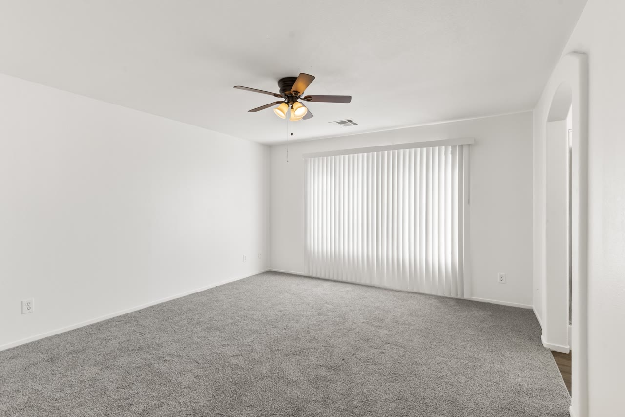 Primary bedroom with a ceiling fan and mountain view at 4655 Gracemont Avenue, Las Vegas 89139