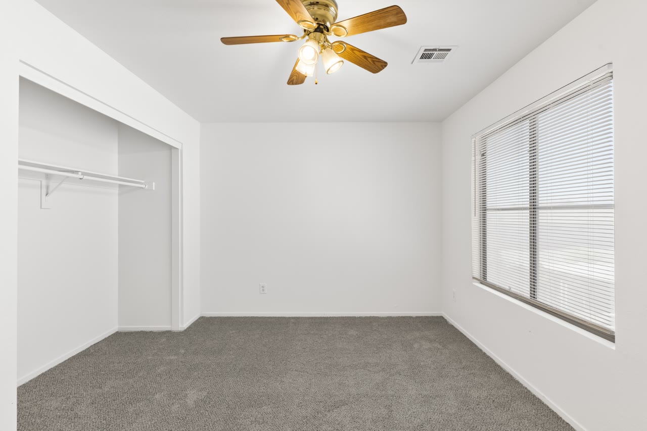 Secondary bedroom with new carpet and a ceiling fan at 4655 Gracemont Avenue, Las Vegas 89139