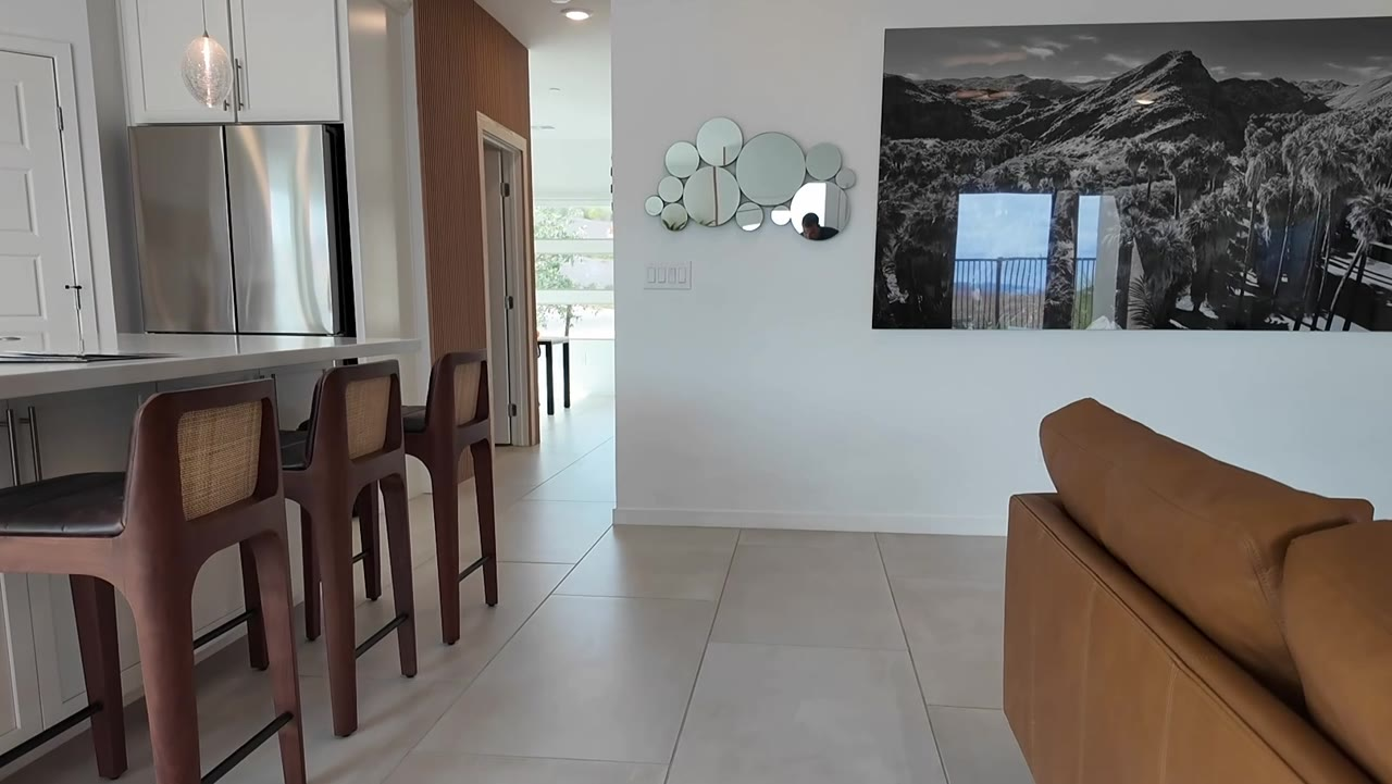 Kitchen island with seating and the great room at 924 Kings Cliff Lane, a 2025 single story 55+ home in Summerlin West