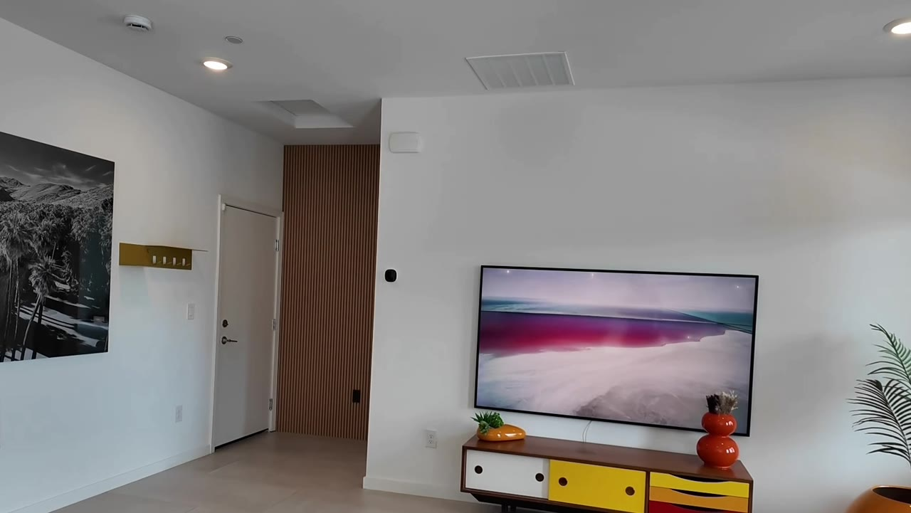 Great room with mounted TV and designer lighting at 924 Kings Cliff Lane, single story Las Vegas retirement home