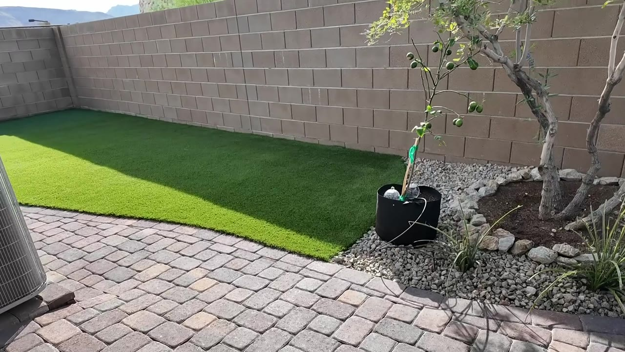 Private paver side courtyard with artificial turf and a Vitex tree at 924 Kings Cliff Lane, Heritage at Stonebridge, Summerlin West