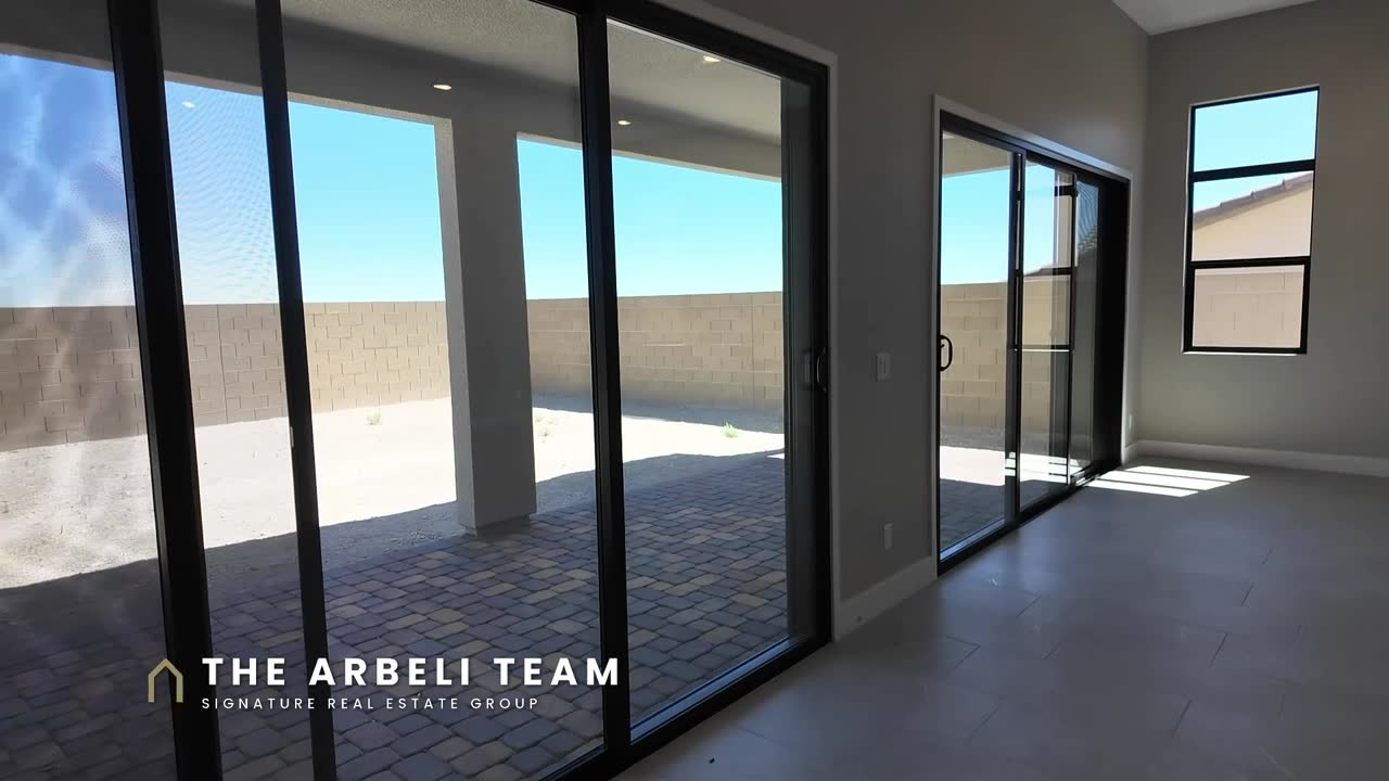 Great room with dual sliders to the covered patio in the Colonial at Ashland at Summerlin, new construction Summerlin